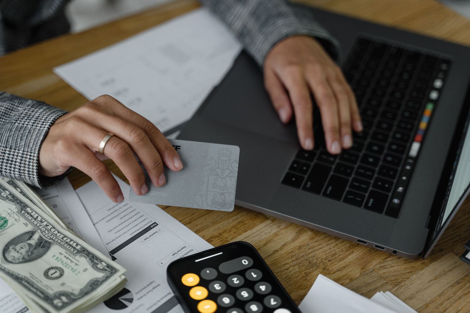 Reviewing credit card statements and a calculator before applying